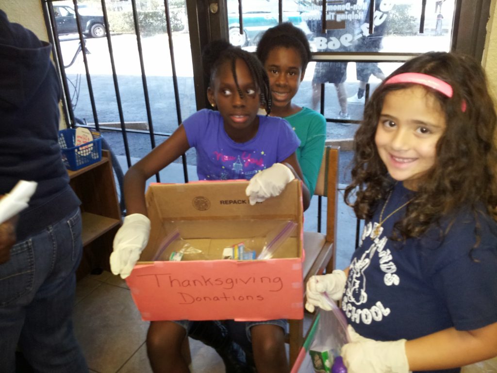 Children volunteer in a non profit organization prepares donations for the needy.