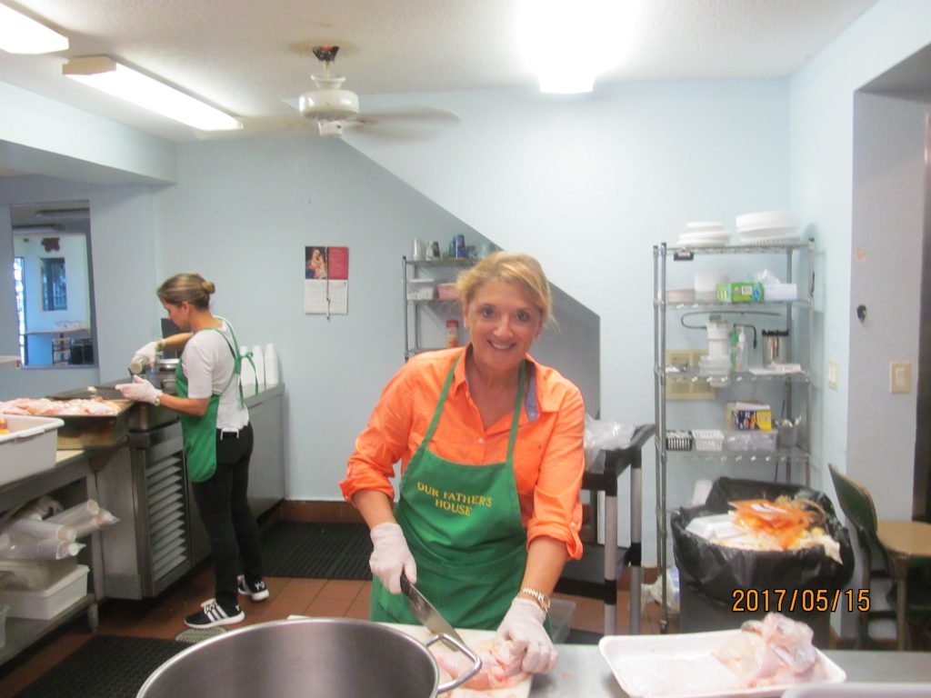 Soup kitchen volunteers staff cooking for homeless people.