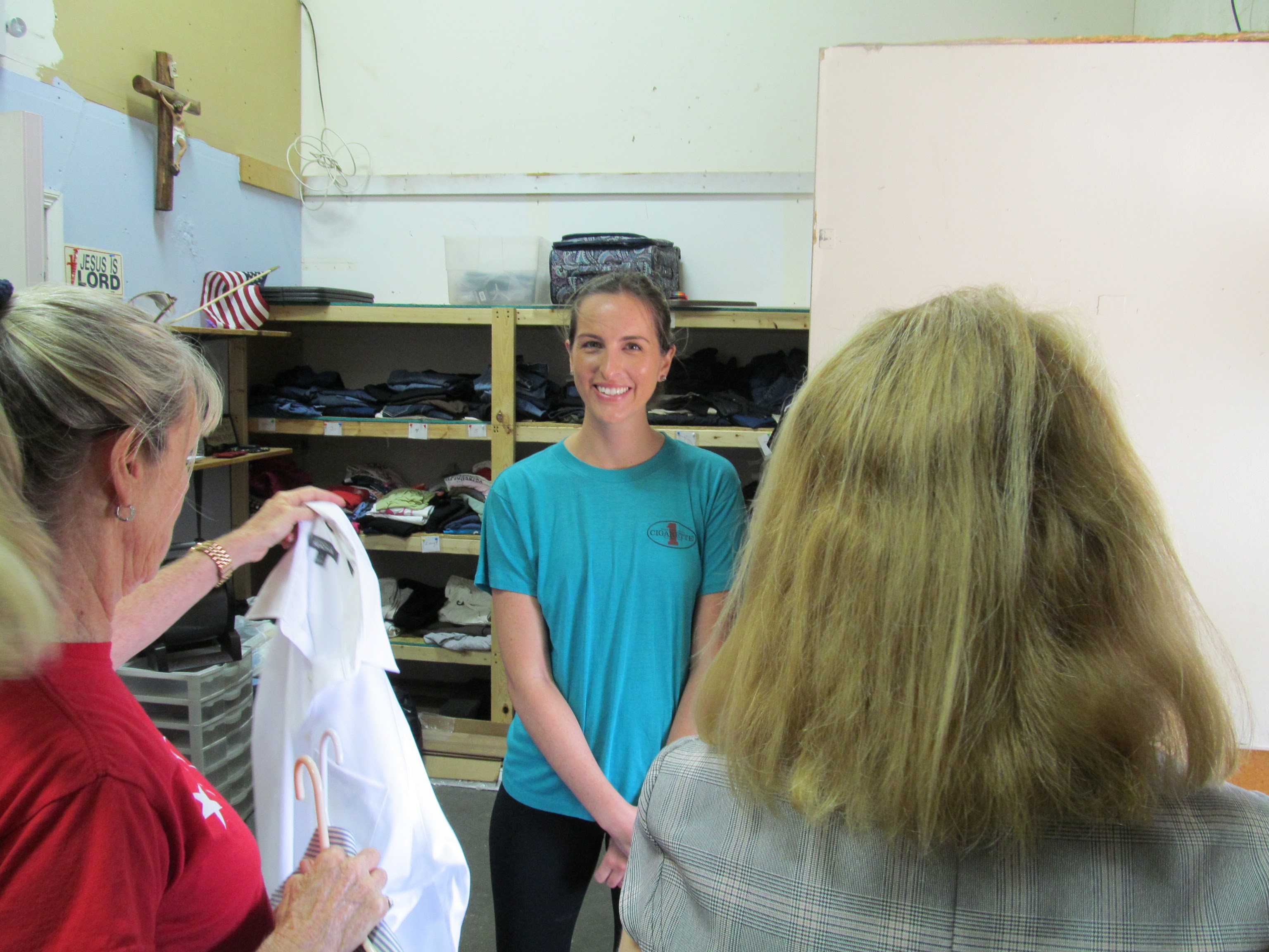 Members of non profit organization shows donated clothes.