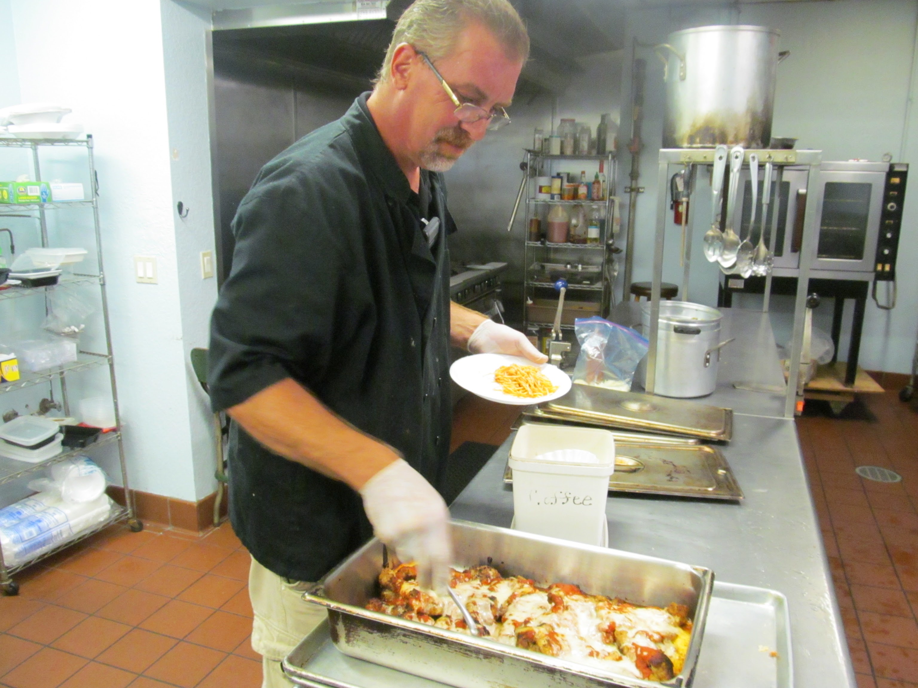Soup kitchen volunteer chef prepares food f.or the homeless people