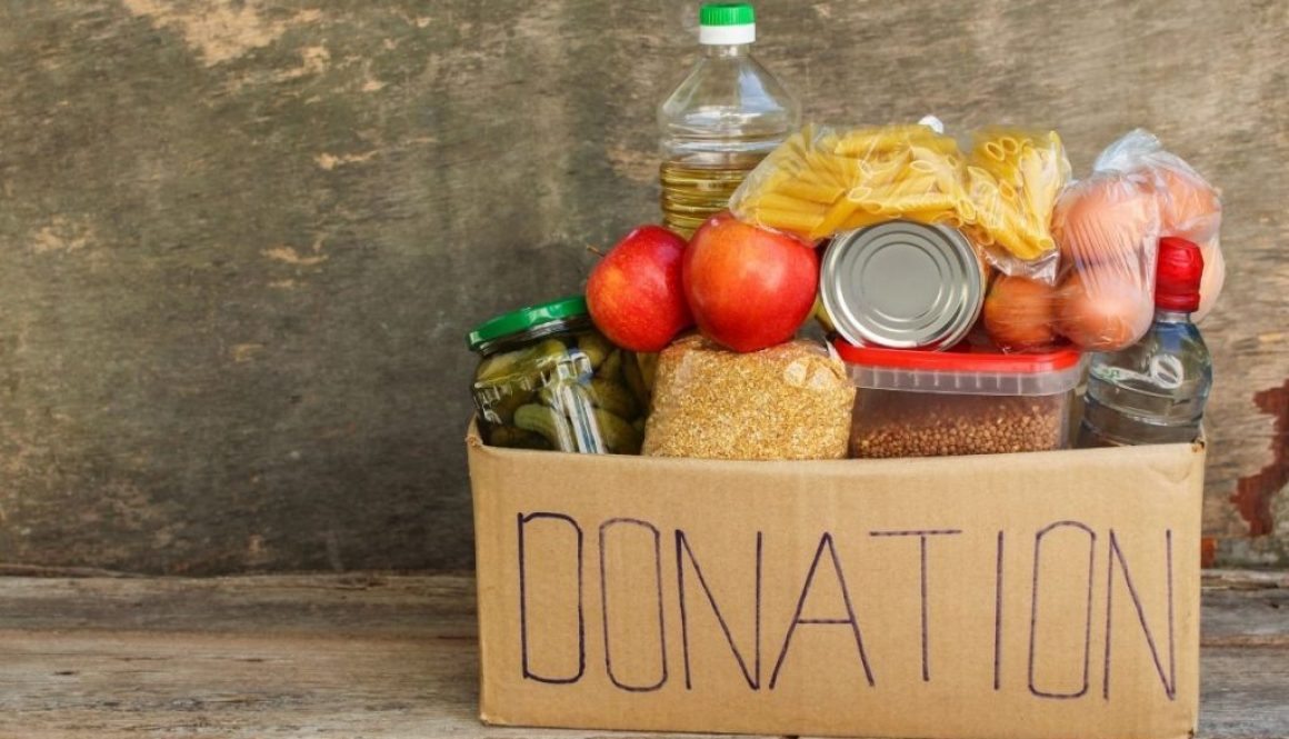 Donation foods for homeless placed under the wooden table