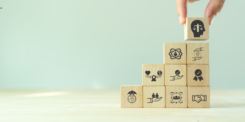 Someone is playing with a block with an icon related to ethics.