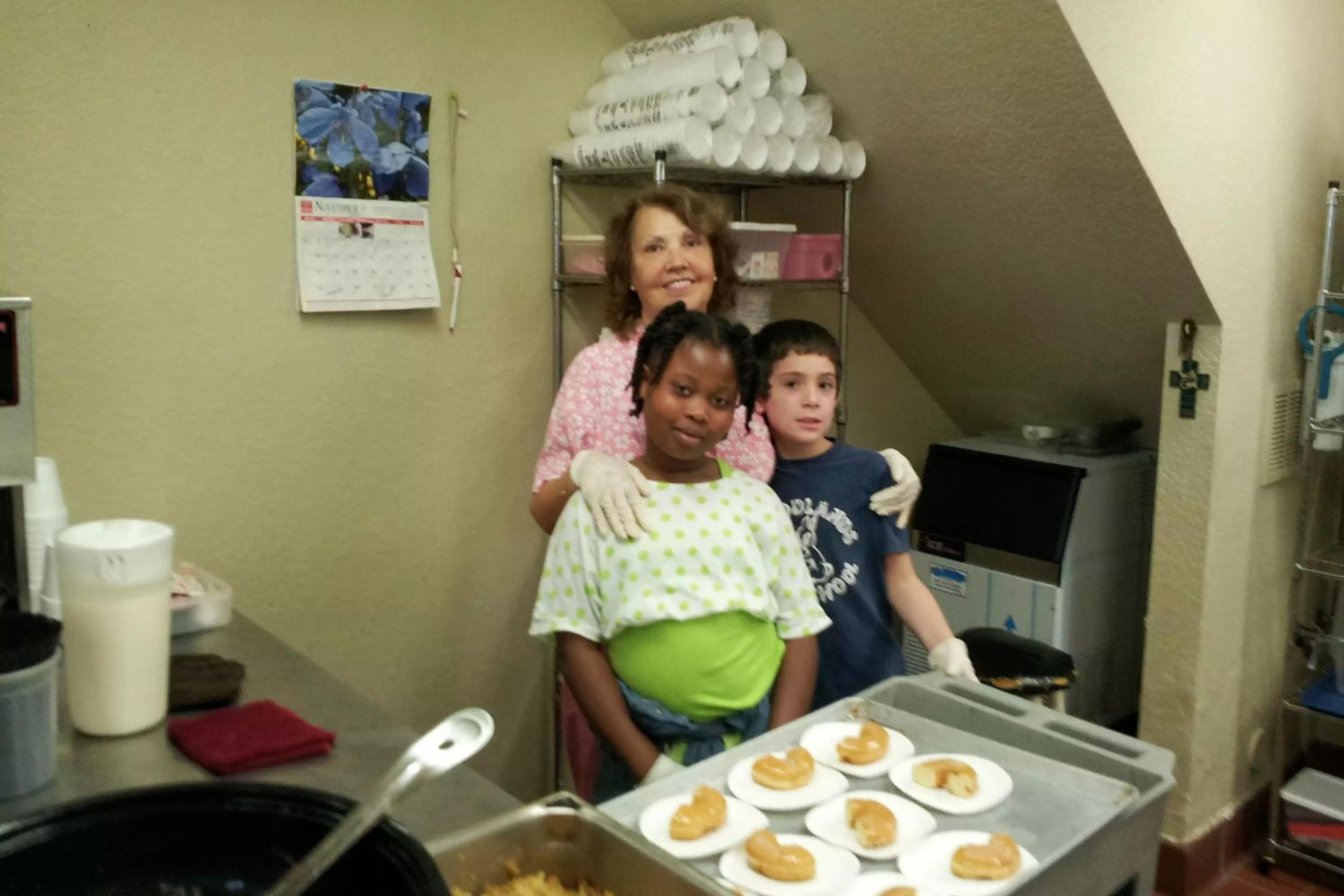 Children volunteering in the kitchen of Our Father's House Soup Kitchen.