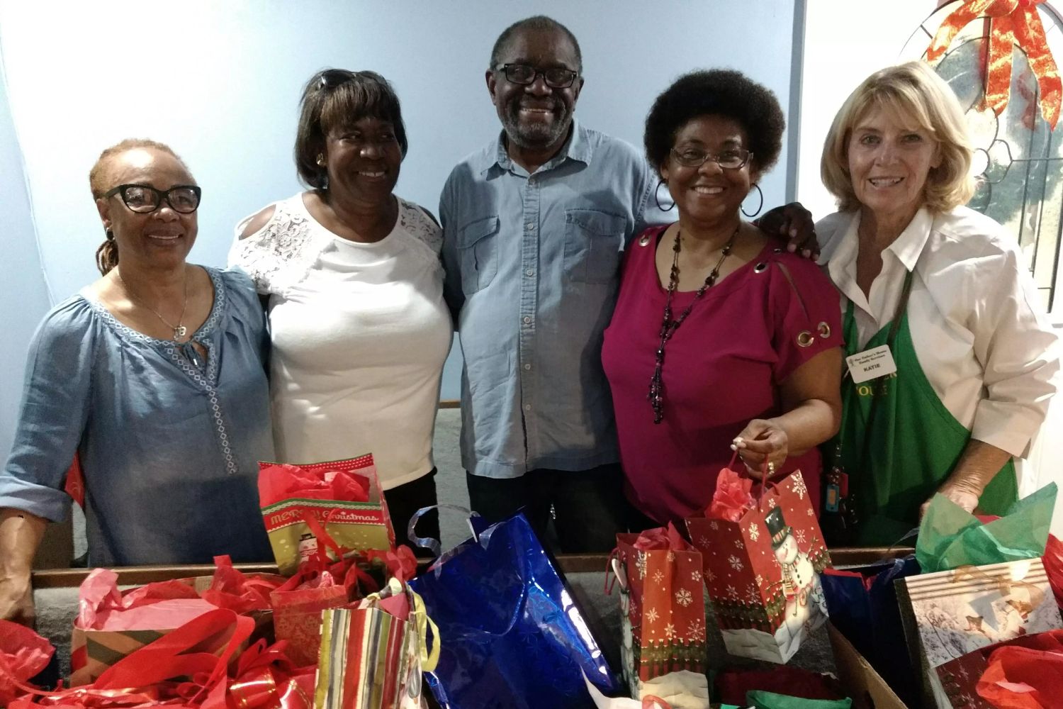 Soup kitchen volunteers at Christmas time with presents.