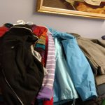 Clothing donations placed on a table at the soup kitchen.