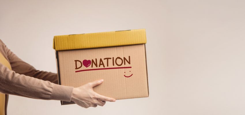 Someone holding a donation box.