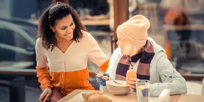 The woman provides food to the homeless elderly, which is an example of a good Samaritan.
