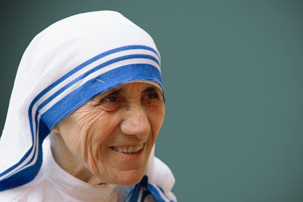 Mother Teresa is smiling while giving inspiration to others.