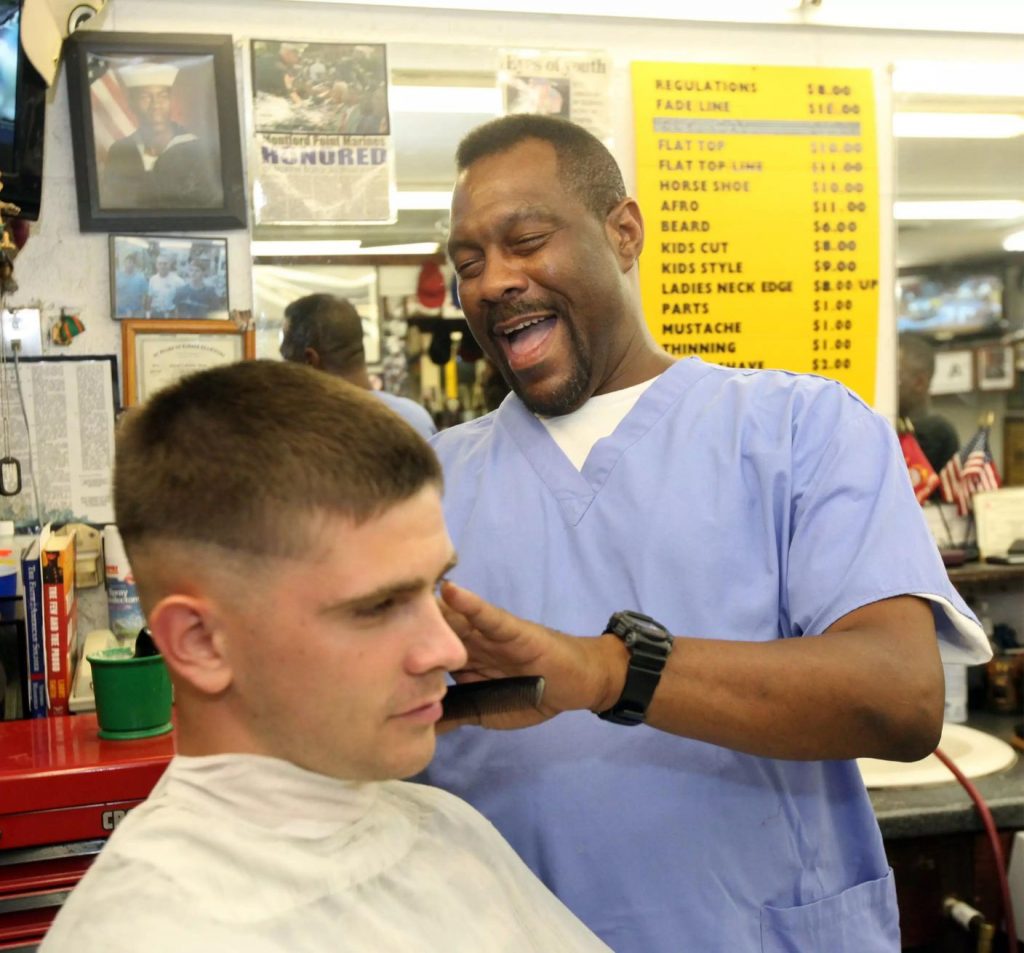 A volunteer barber gives out free haircuts.