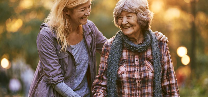 quotes-giving-back-helping-others2 Younger woman supporting an elderly woman with a warm smile, embodying quotes giving back helping others.