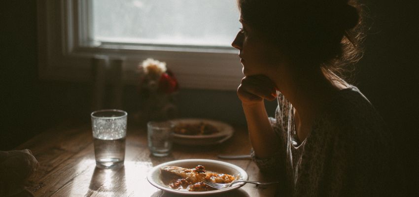 The woman still ate despite her sadness and loneliness.